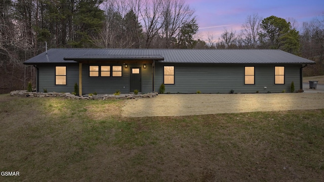 view of front facade with metal roof and a front yard