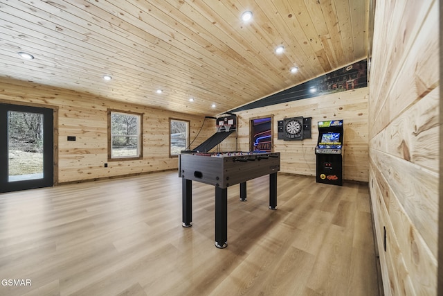 rec room with wooden walls, wood ceiling, vaulted ceiling, and light wood finished floors