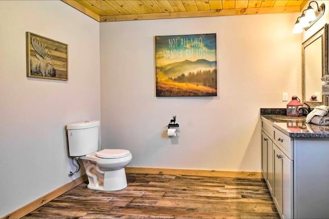 bathroom with hardwood / wood-style flooring, vanity, wood ceiling, and toilet