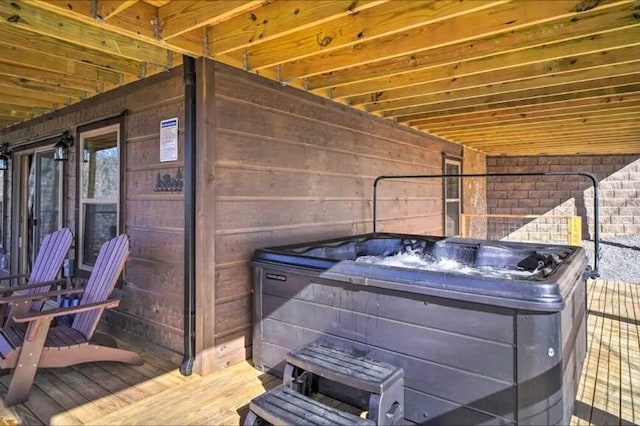 wooden deck featuring a hot tub