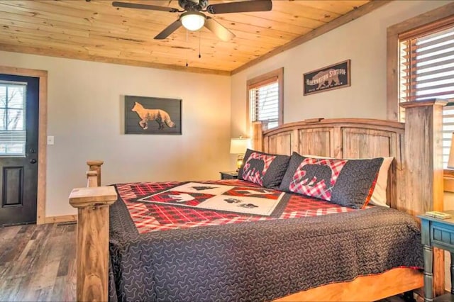 bedroom featuring hardwood / wood-style floors, ceiling fan, wood ceiling, and multiple windows