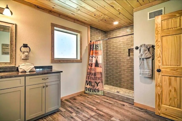 bathroom with hardwood / wood-style floors, vanity, wooden ceiling, and a shower with shower curtain