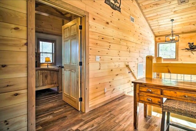 interior space with wooden walls, dark hardwood / wood-style floors, vaulted ceiling, and wooden ceiling