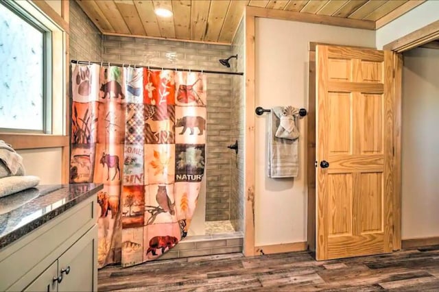 bathroom with a shower with curtain, vanity, wood-type flooring, and wood ceiling