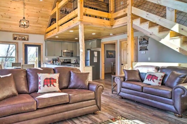 living room featuring a high ceiling, an inviting chandelier, wooden ceiling, and wood-type flooring