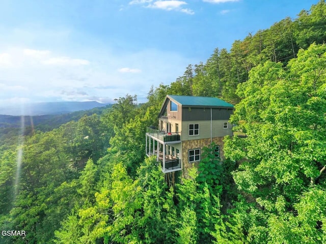 exterior space featuring a wooded view