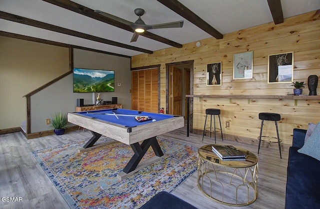 recreation room featuring beamed ceiling, wood finished floors, wooden walls, pool table, and ceiling fan