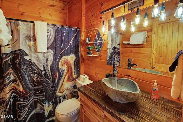 full bathroom featuring wood walls, toilet, vanity, and a shower with curtain