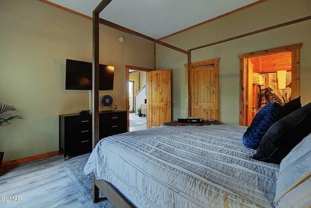 bedroom with baseboards and light wood finished floors