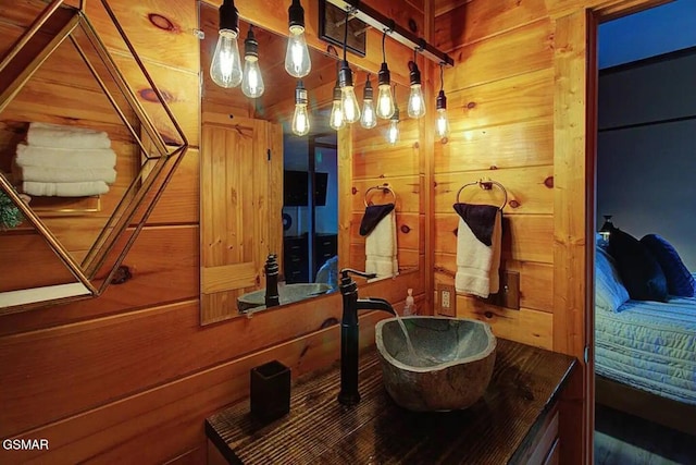 bathroom with wooden walls and a sink