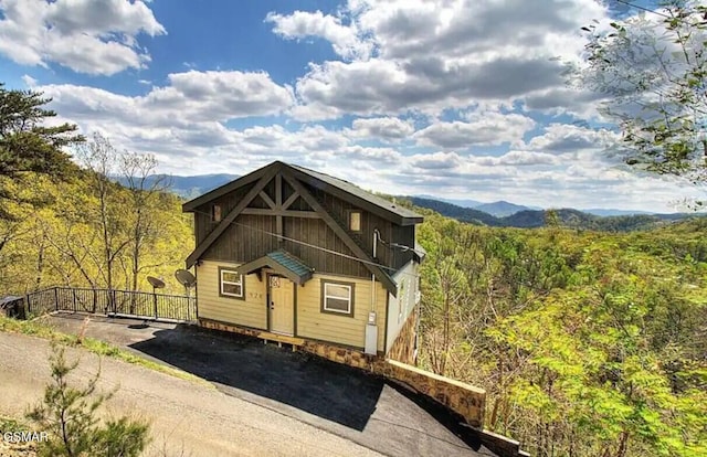 exterior space with a mountain view and a wooded view