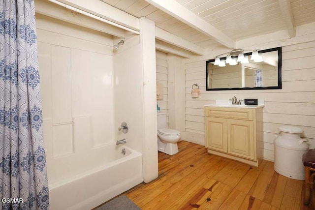 full bath with toilet, wood finished floors, shower / bath combo with shower curtain, wood walls, and beam ceiling