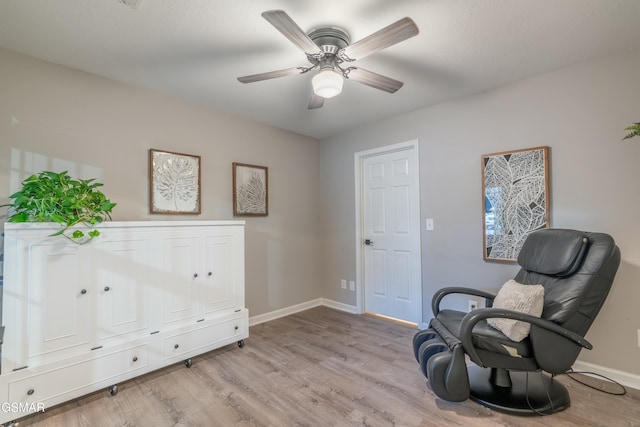 sitting room with ceiling fan and light hardwood / wood-style floors