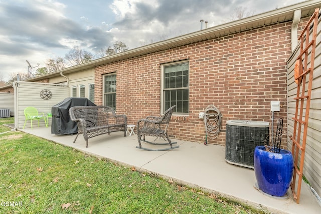 back of property with a patio area, central air condition unit, and a lawn