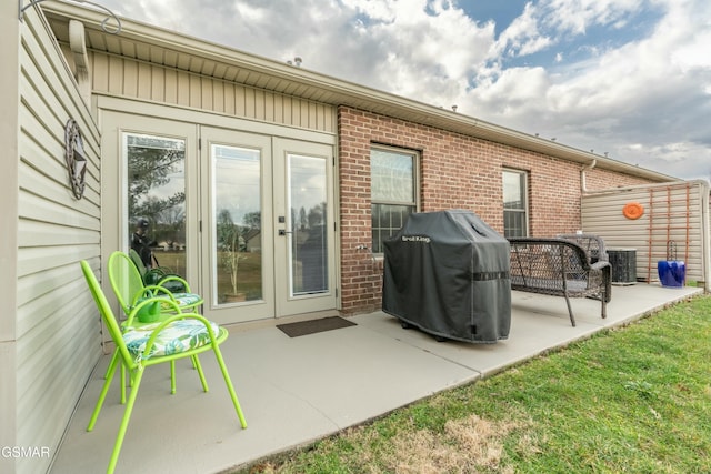 rear view of property with central AC unit and a patio