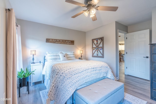 bedroom with wood-type flooring and ceiling fan