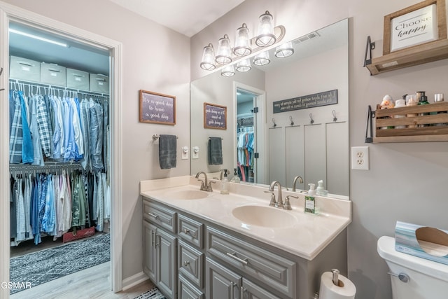 bathroom featuring vanity, toilet, and hardwood / wood-style floors