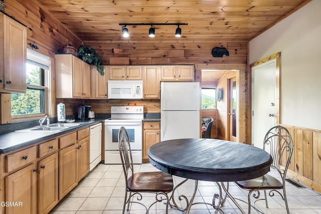 415 Big Bear Way, Pigeon Forge, TN 37863 - kitchen featuring white appliances, track lighting, dark countertops, wood walls, and light tile patterned floors