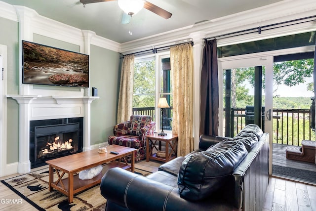 415 Big Bear Way, Pigeon Forge, TN 37863 - living room featuring a lit fireplace, a ceiling fan, wood finished floors, and ornamental molding
