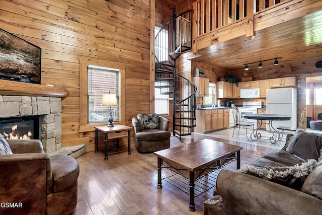 415 Big Bear Way, Pigeon Forge, TN 37863 - living area featuring healthy amount of natural light, wooden walls, stairway, light wood finished floors, and a stone fireplace