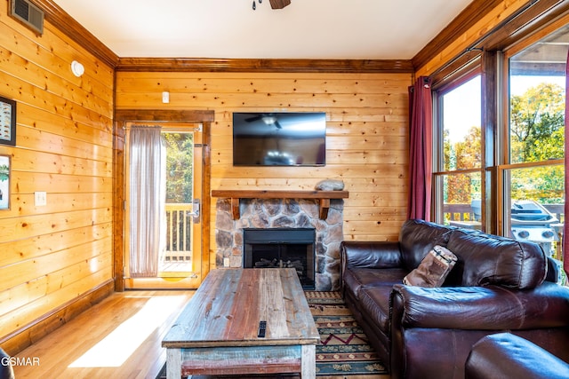 415 Big Bear Way, Pigeon Forge, TN 37863 - living area with wood finished floors, wooden walls, and a fireplace