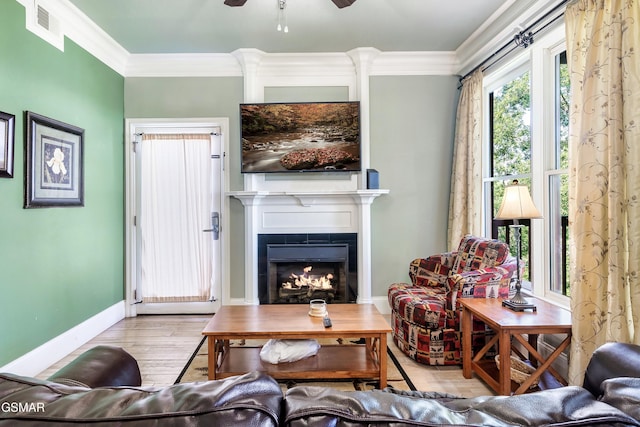 415 Big Bear Way, Pigeon Forge, TN 37863 - living area featuring a lit fireplace, crown molding, wood finished floors, and a ceiling fan