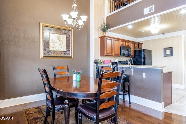 415 Big Bear Way, Pigeon Forge, TN 37863 - dining area featuring light wood-type flooring, a chandelier, and crown molding