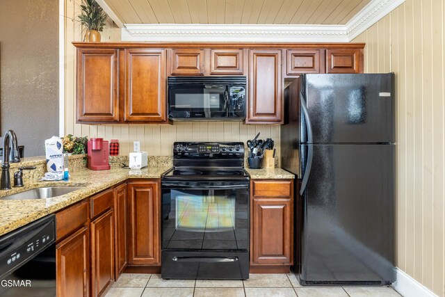 415 Big Bear Way, Pigeon Forge, TN 37863 - kitchen with black appliances, light stone counters, crown molding, light tile patterned floors, and brown cabinets