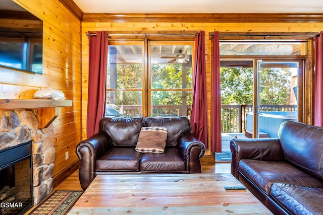 415 Big Bear Way, Pigeon Forge, TN 37863 - living area with wood walls, wood finished floors, a fireplace, and a ceiling fan