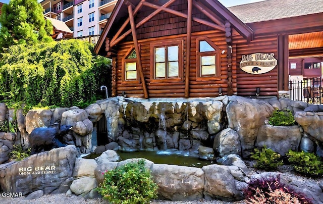 415 Big Bear Way, Pigeon Forge, TN 37863 - view of side of property with log siding, a garden pond, and roof with shingles