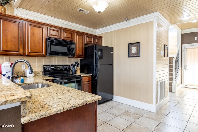 415 Big Bear Way, Pigeon Forge, TN 37863 - kitchen featuring black appliances, crown molding, light stone countertops, light tile patterned floors, and brown cabinets