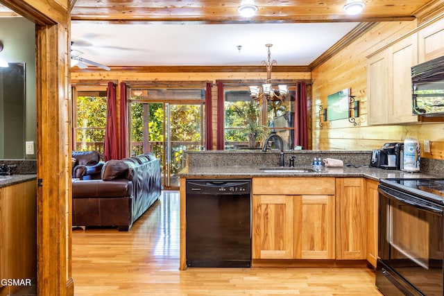 415 Big Bear Way, Pigeon Forge, TN 37863 - kitchen featuring black appliances, wood walls, dark stone counters, a peninsula, and a chandelier