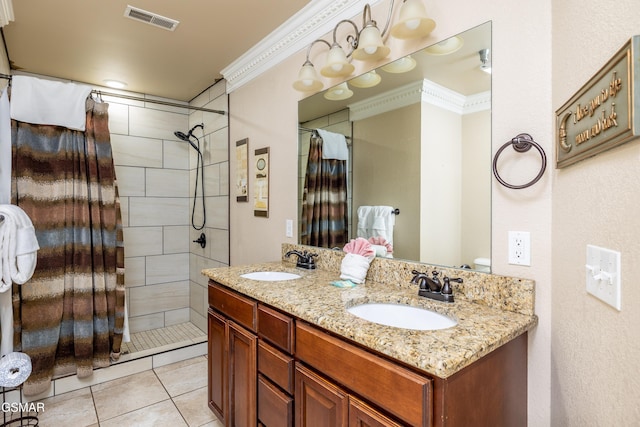 415 Big Bear Way, Pigeon Forge, TN 37863 - bathroom with a tile shower, double vanity, ornamental molding, and tile patterned flooring