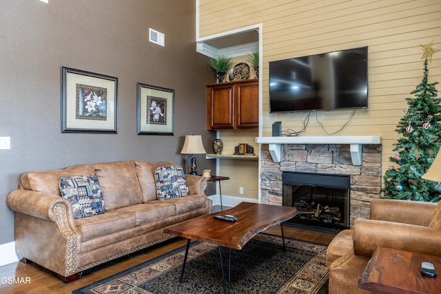 415 Big Bear Way, Pigeon Forge, TN 37863 - living area featuring wood finished floors, a stone fireplace, and wooden walls