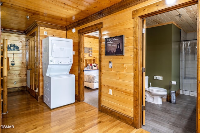 415 Big Bear Way, Pigeon Forge, TN 37863 - washroom with wooden ceiling, wood walls, stacked washer / dryer, and wood finished floors
