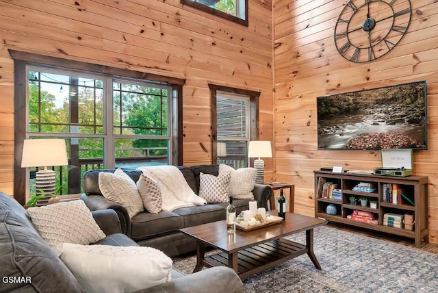 668 Stockton Dr, Sevierville, TN 37876 - living room featuring wooden walls, a high ceiling, and wood finished floors