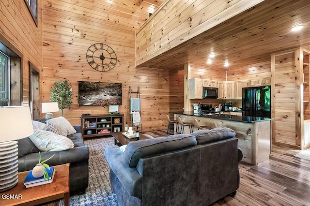 668 Stockton Dr, Sevierville, TN 37876 - living room with wood walls, wood finished floors, wooden ceiling, and a high ceiling