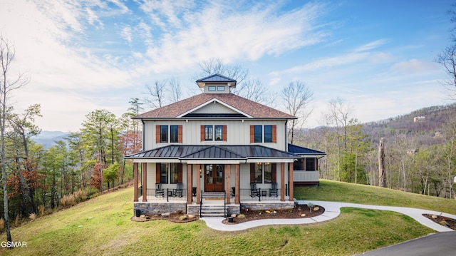 view of front of property with a front yard and covered porch