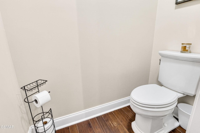 bathroom with hardwood / wood-style flooring and toilet