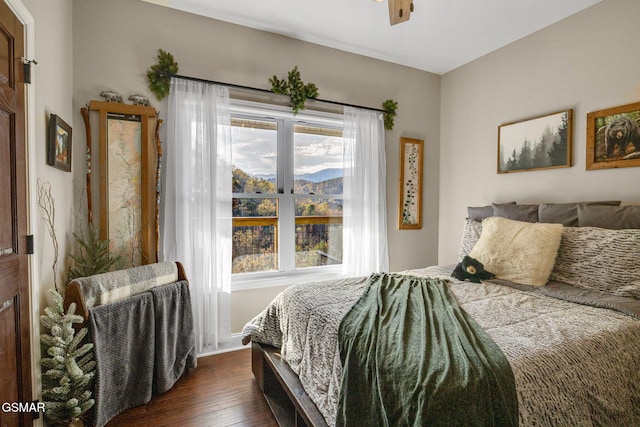 bedroom with ceiling fan and dark hardwood / wood-style flooring