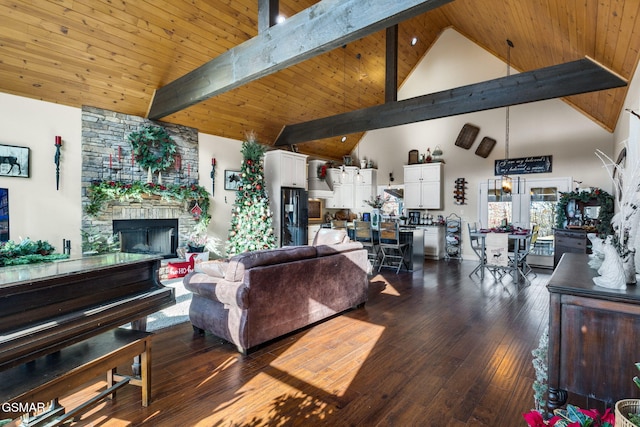 living room with beamed ceiling, high vaulted ceiling, dark hardwood / wood-style floors, a fireplace, and wood ceiling