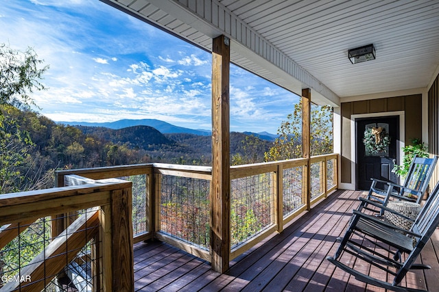 wooden deck with a mountain view