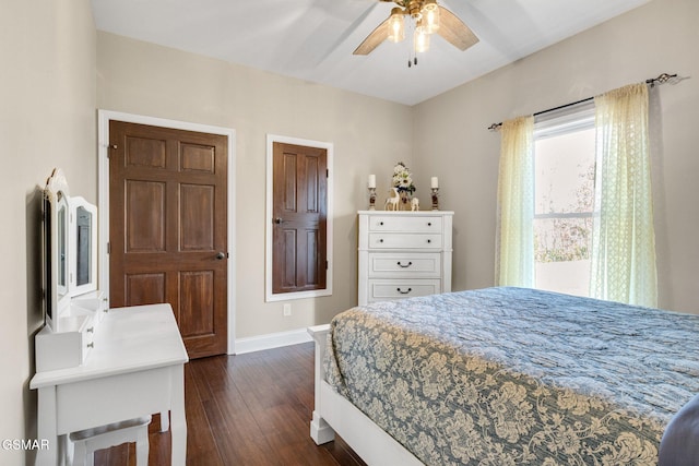 bedroom with dark hardwood / wood-style floors and ceiling fan