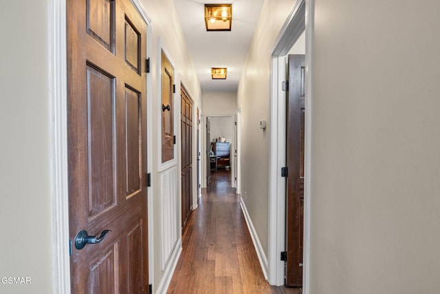 hall with hardwood / wood-style flooring