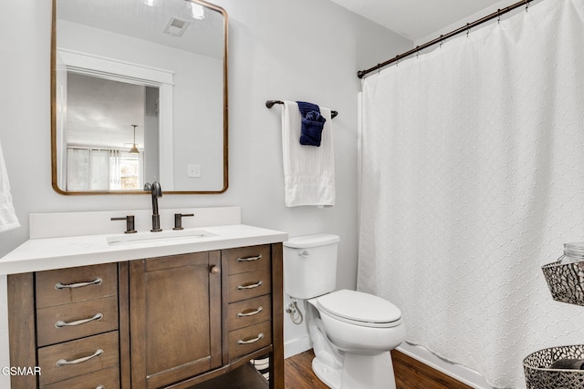 bathroom with vanity, hardwood / wood-style flooring, and toilet