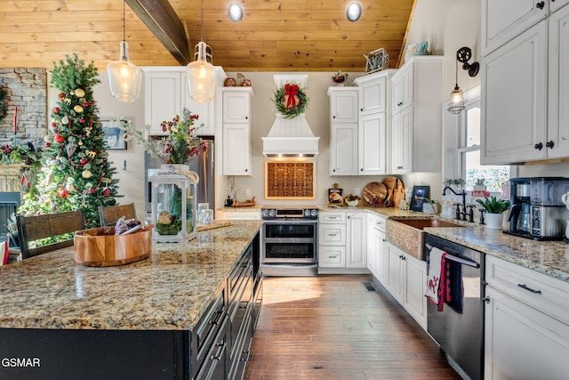 kitchen with wooden ceiling, premium range hood, hanging light fixtures, appliances with stainless steel finishes, and white cabinetry