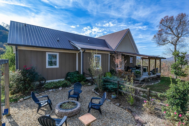 back of property featuring an outdoor fire pit