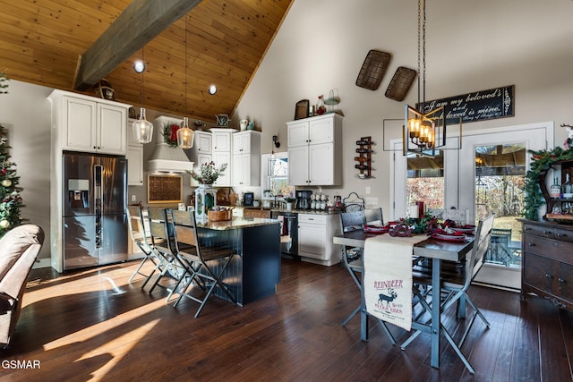 kitchen featuring white cabinets, stainless steel fridge with ice dispenser, and high vaulted ceiling