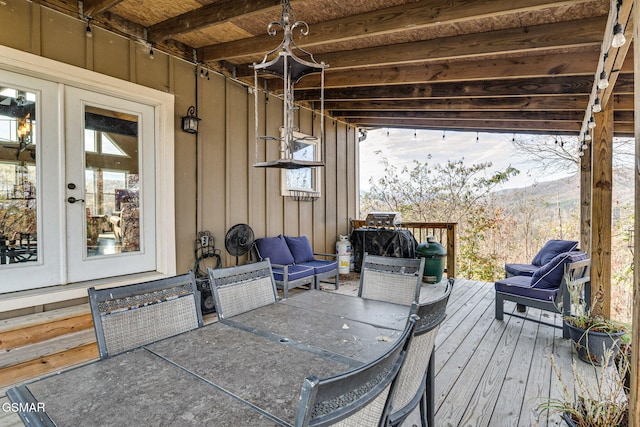 view of patio with a deck with mountain view, french doors, and outdoor lounge area