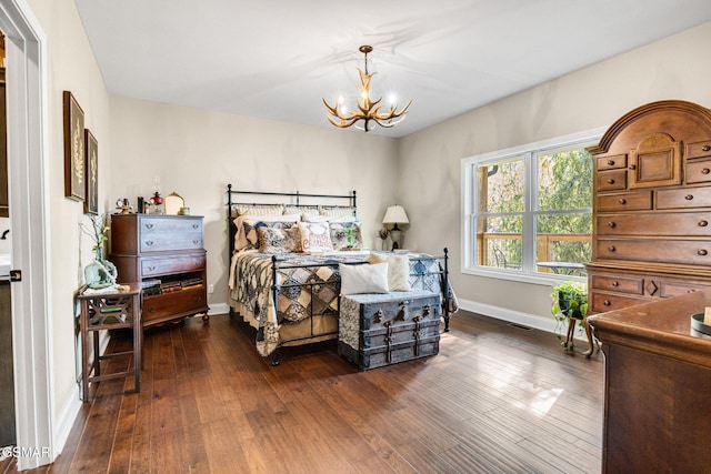 bedroom featuring dark hardwood / wood-style flooring and a notable chandelier